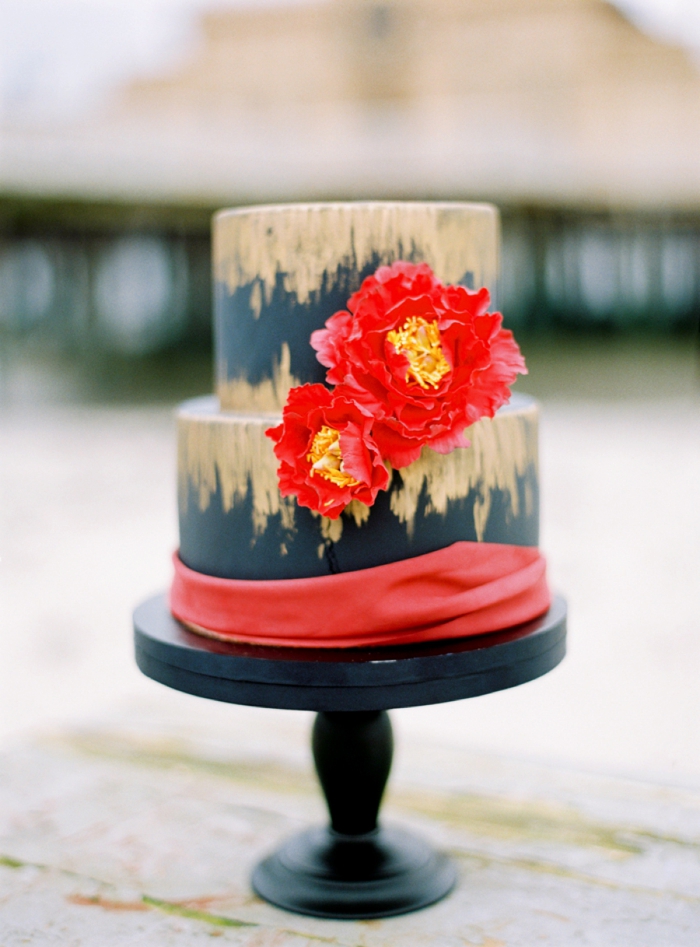 Black red and golden wedding cake with silk ribbon from a Swedish seaside winter wedding inspiration