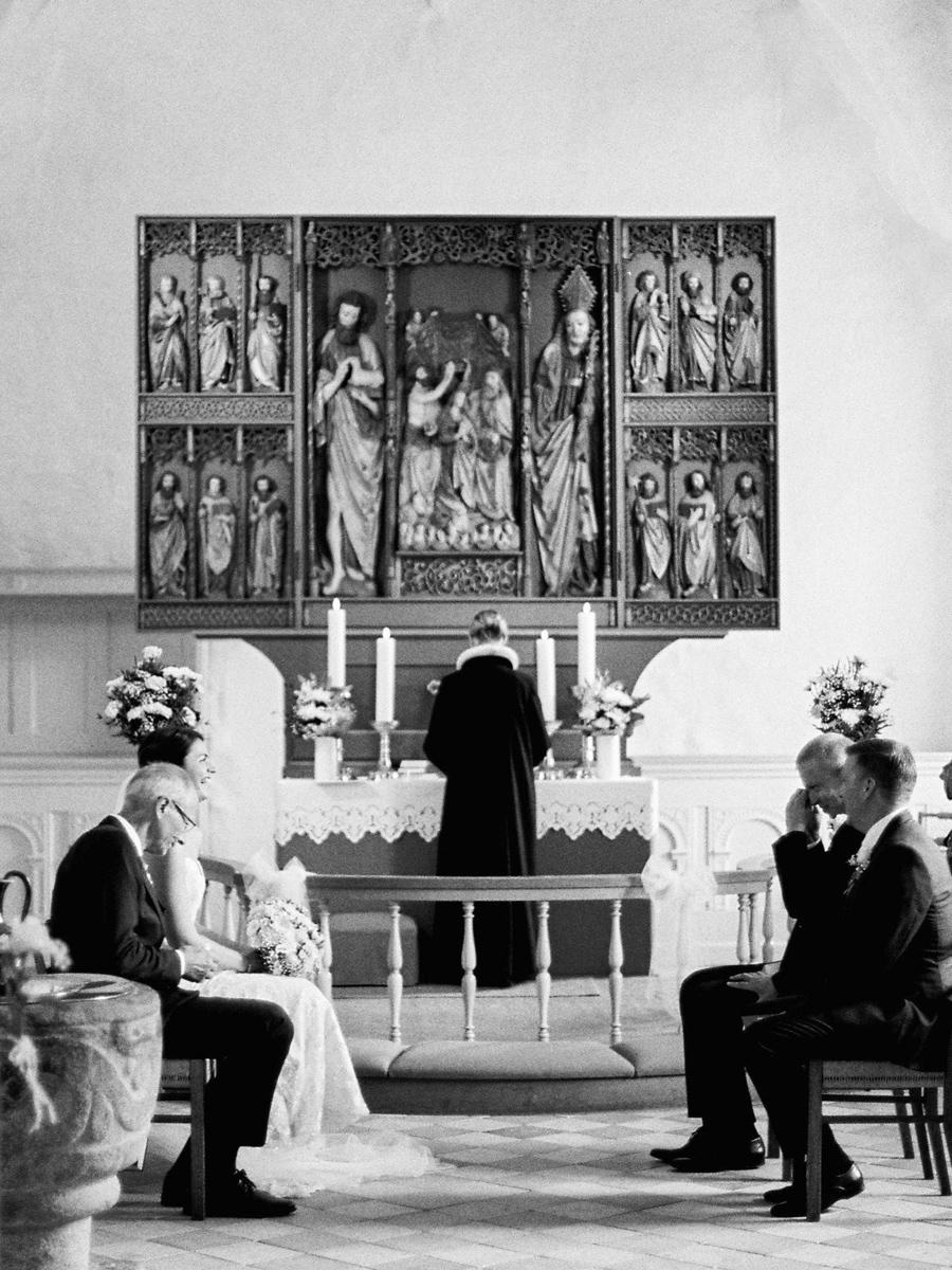 bride and groom during sitting ceremony in Denmark church