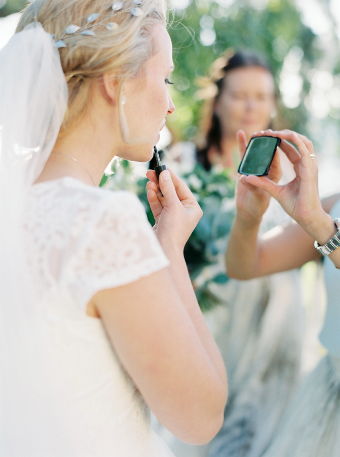 Bride putting on lipgloss