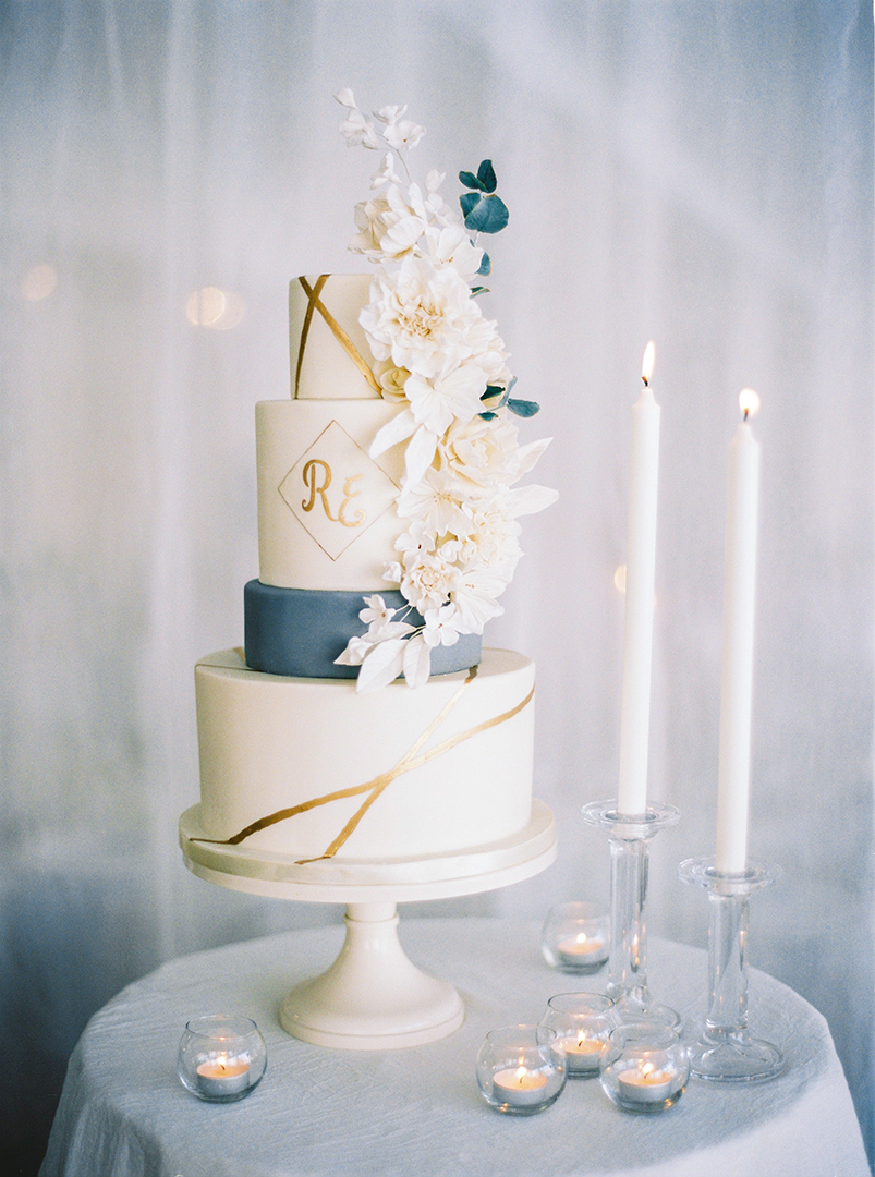 Winter wedding cake in white, dusty blue photographed by 2 Brides Photography