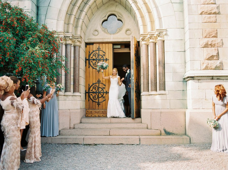 Bride and groom exiting Oscars kyrkan after the wedding ceremony