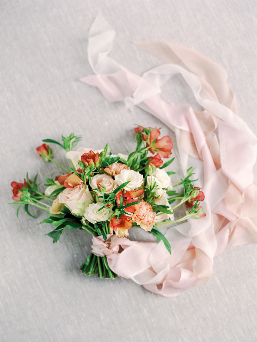 Spring wedding bouquet with pops of colors in rust cream and blu