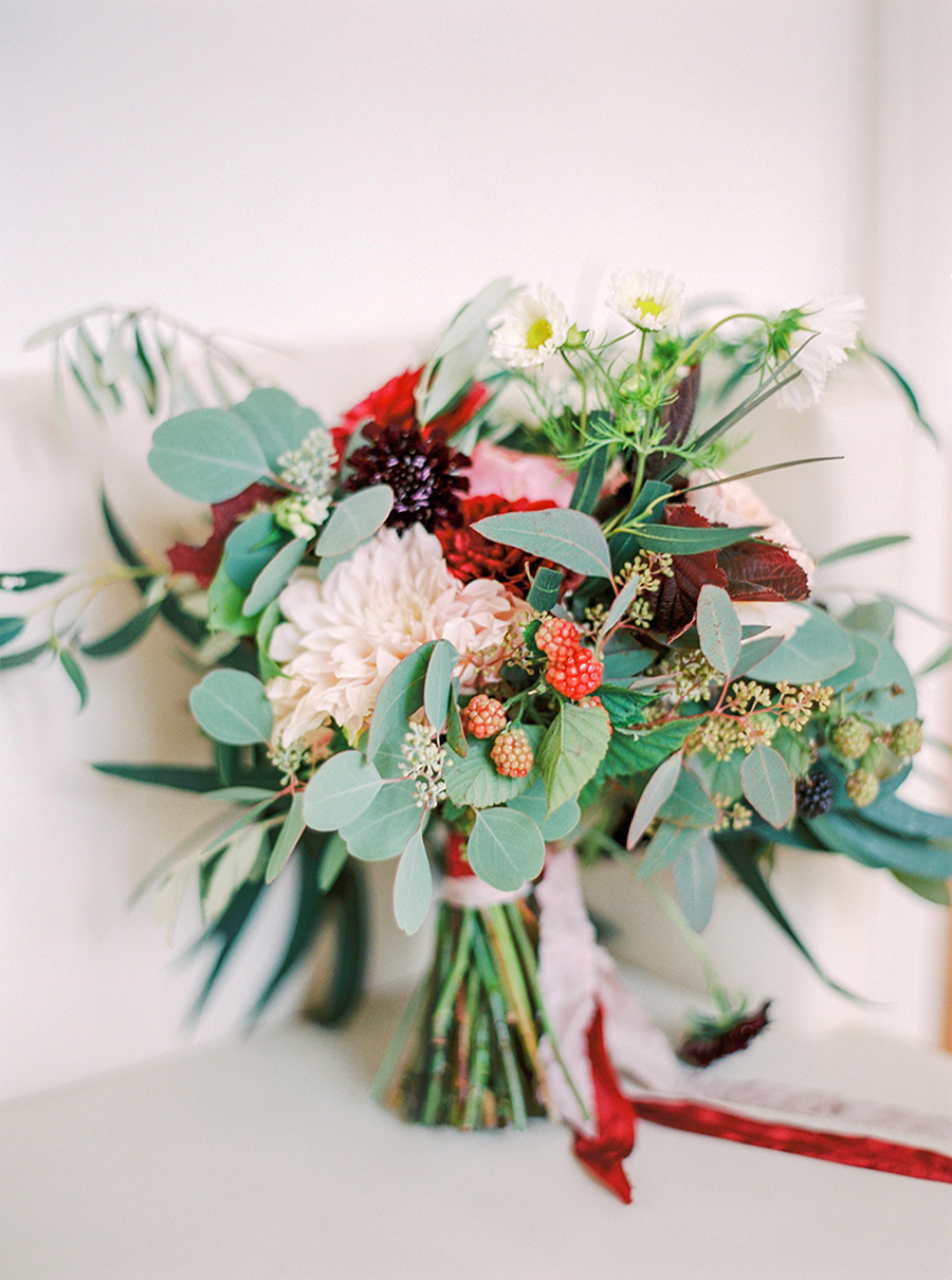 Wedding bouquet with wild berries and pops of red and purple