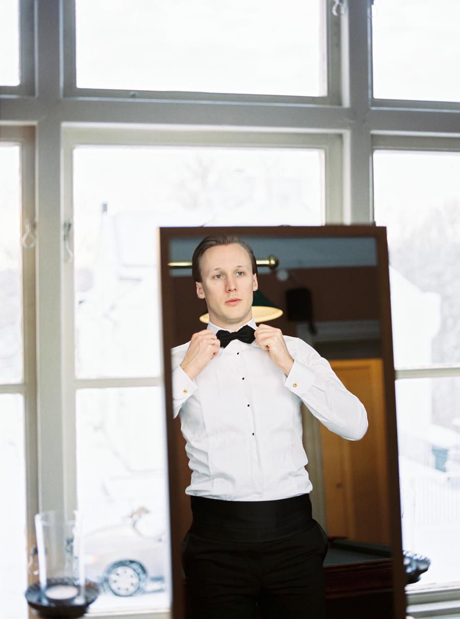 groom in front of mirror winter wedding 2 Brides Photography