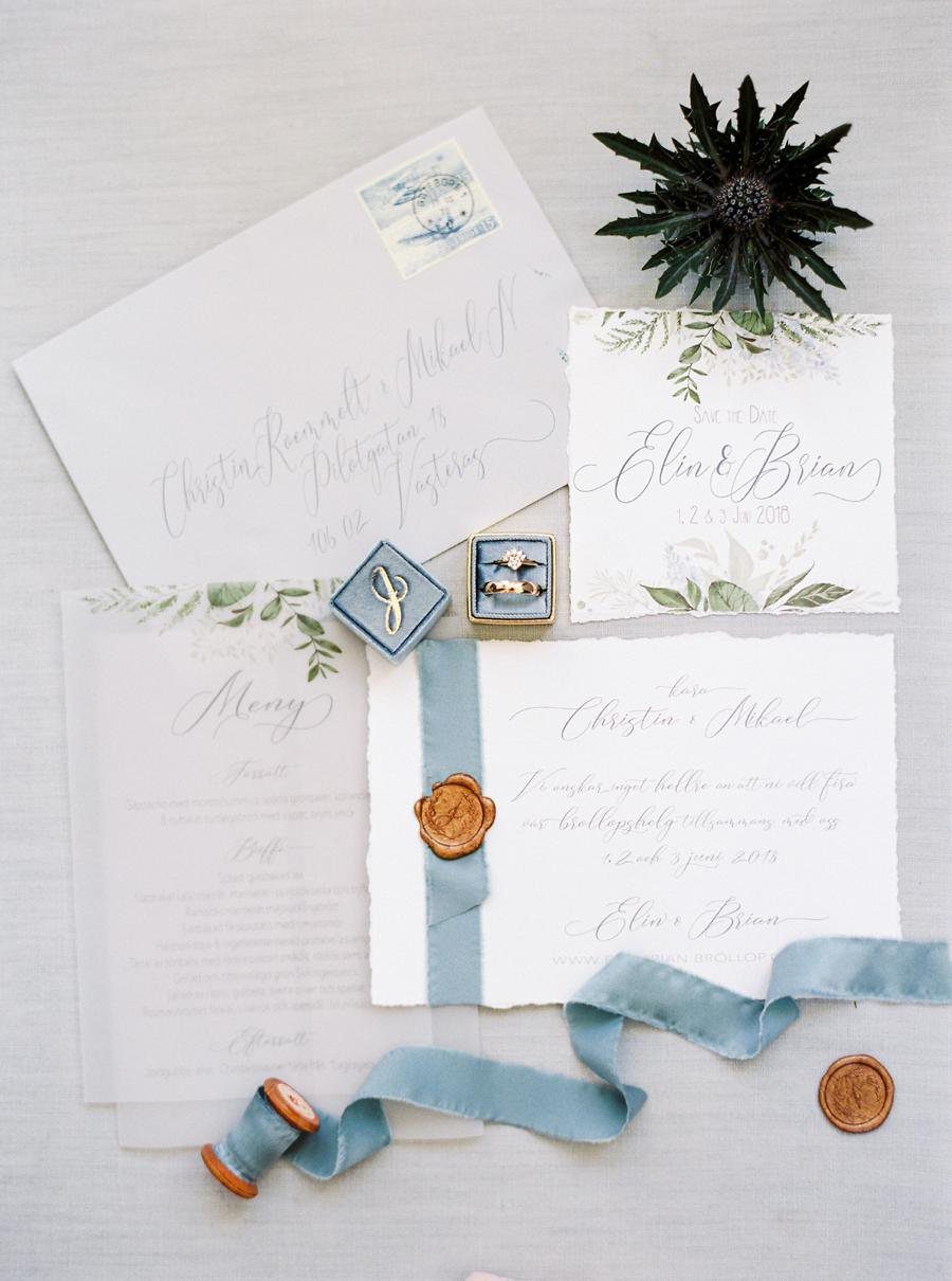 Calligraphy wedding invitation in dusty blue and gold colors
