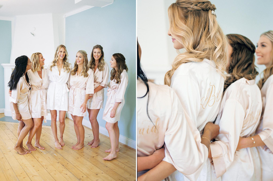 Bride and bridesmaids in matching blush pink robes toasting in champagne