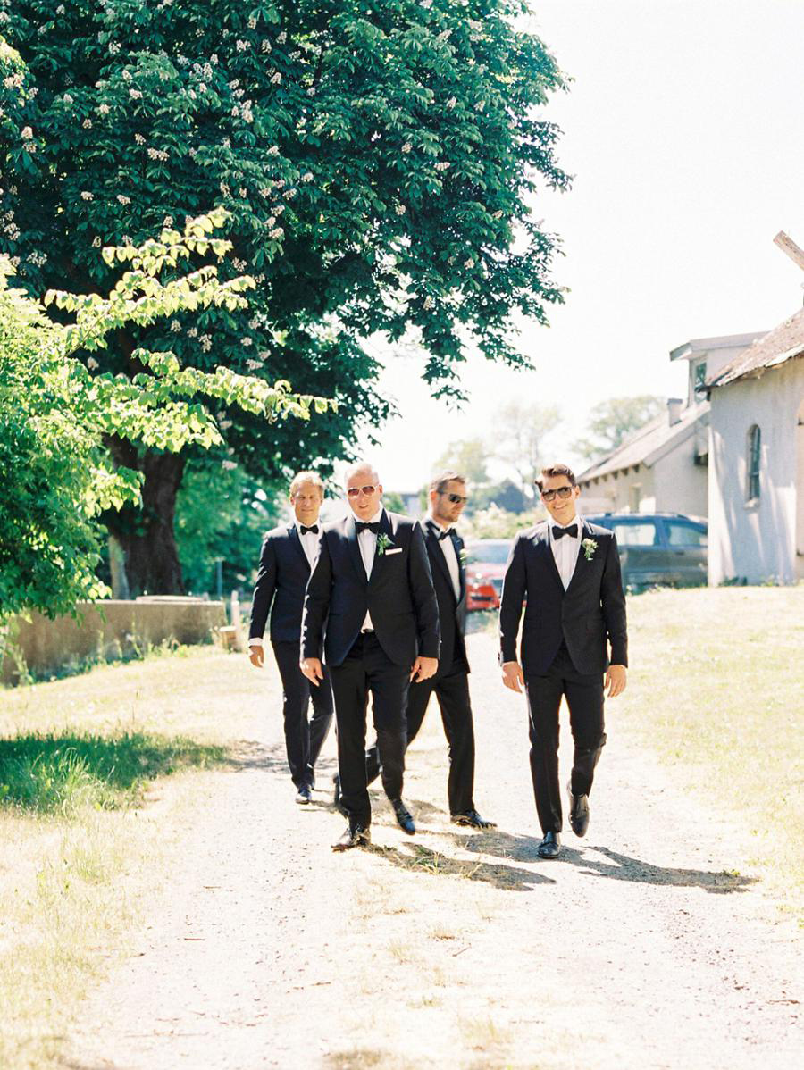 Groom and the groomsmen walking towards the ceremony site