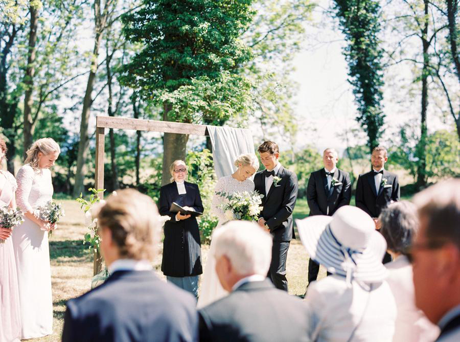 Bride and groom exchanging vows during an outdoors forrest wedding ceremony