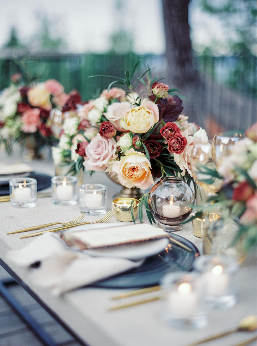 Peach and burgundy wedding table arrangements
