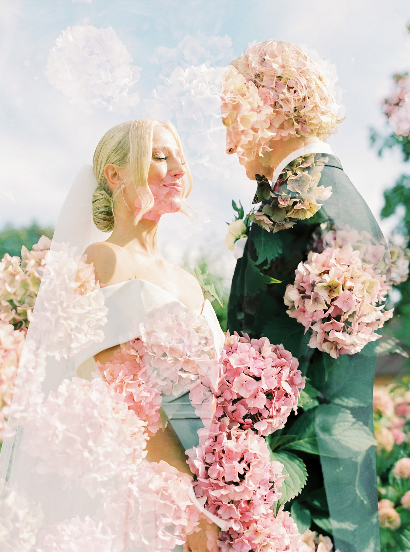Double exposure in camera on film with the bride and groom mixed with pink flowers